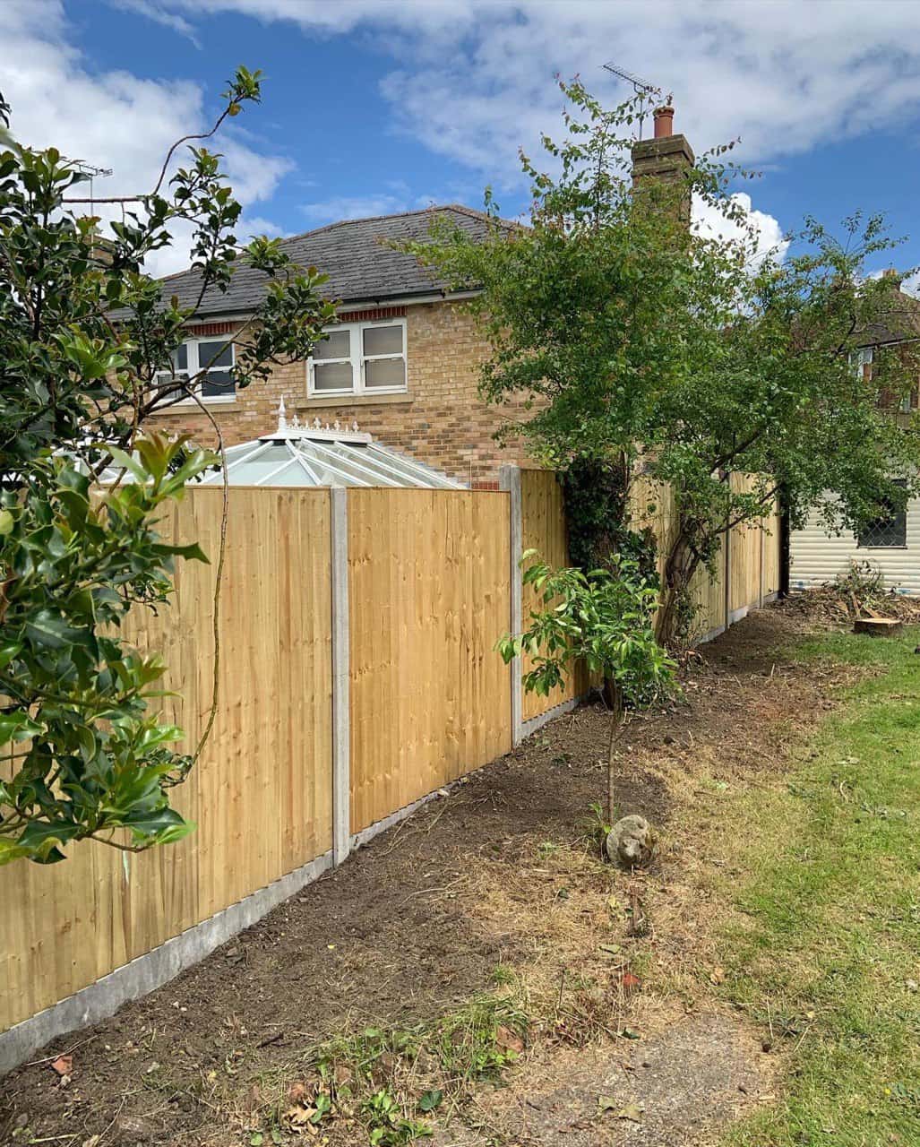 This is a photo of fence panels installed in a residential garden using concrete posts and gravel boards. Installed by Fast Fix Fencing Wimblington